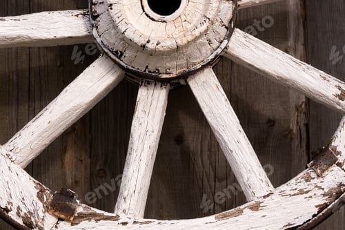 Preview: An old wooden carriage wheel hanging on the barn wall