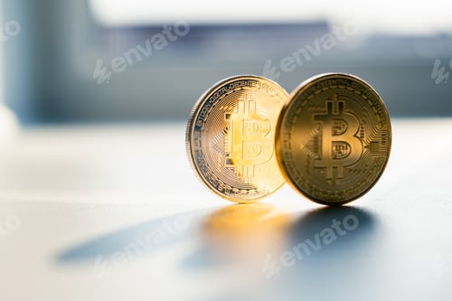 Preview: Golden bitcoin coin in man hand closeup