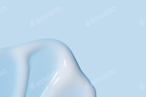 Preview: Texture of white cream on blue background. Smear of moisturizer close up. Lotion swatch
