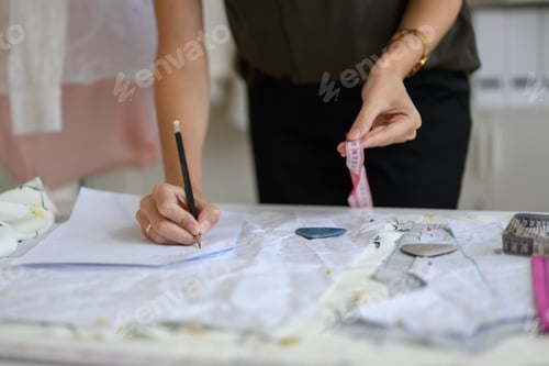 Preview: Beautiful woman dressmaker working in workshop studio