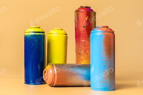 Preview: used colorful spray cans isolated on orange background b