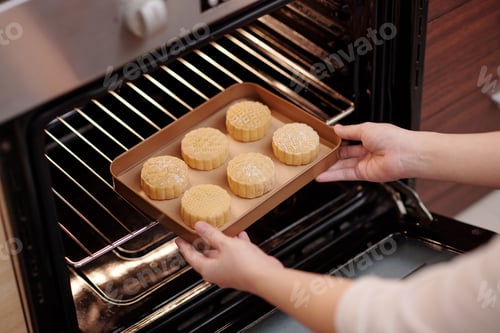 Preview: Woman Putting Mooncakes in Oven