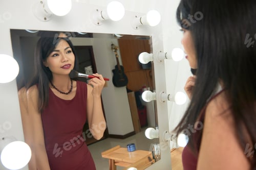 Preview: Asian woman applying make-up