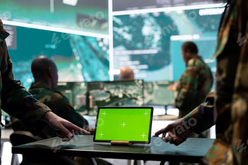 Preview: Two servicemen working in team with a green screen mockup