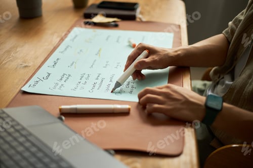 Preview: Young Adult Caucasian Man Planning Weekly Schedule Using Marker at Desk