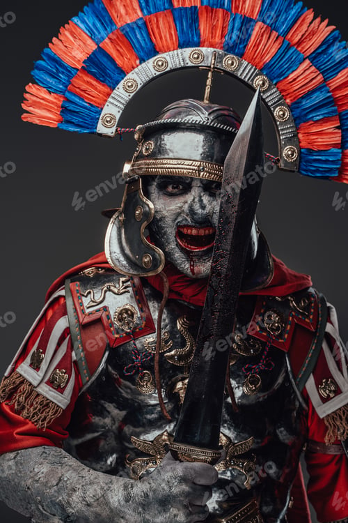 Preview: Cruel zombie centurion posing with gladius isolated on gray