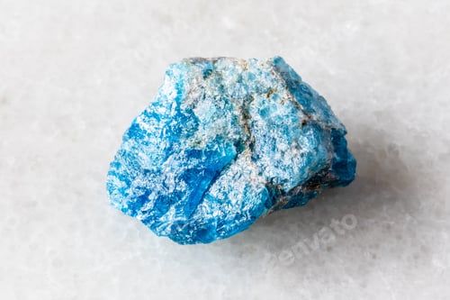 Preview: sample of unworked apatite rock on white marble