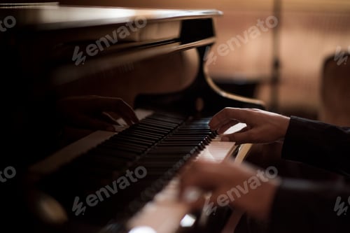 Preview: Hands of young man playing piano keys in bar at night