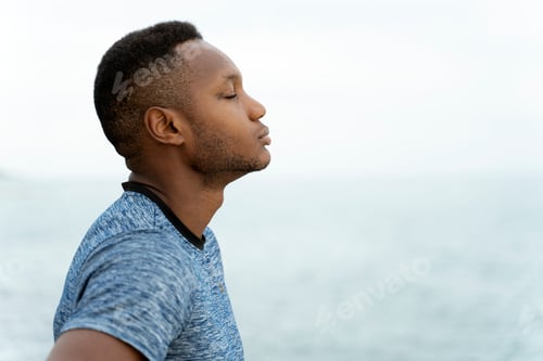 Preview: Man standing with closed eyes while relaxing after sport and enjoying of good weather