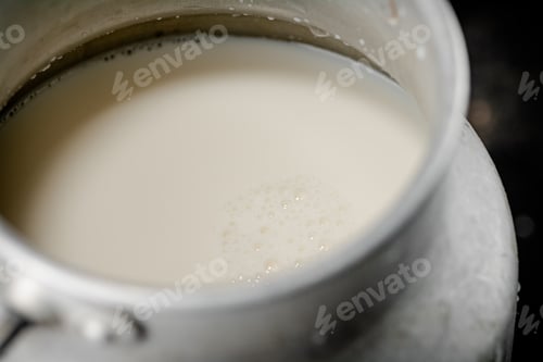 Preview: Fresh milk in a can on the table.