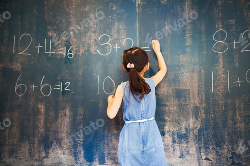 Preview: A group of children in school. A girl writing in chalk on a chalkboard.