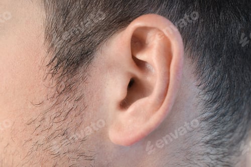 Preview: Ear of young man all over background, close up