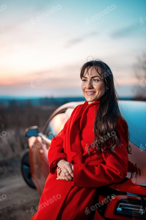 Preview: Woman posing near a red car