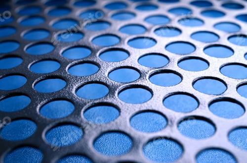 Preview: Black metal computer case panel mesh with holes on blue background. Abstract close up image