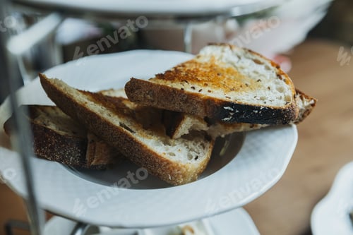 Preview: Toasted bread slices on white plate for breakfast and rustic food concept