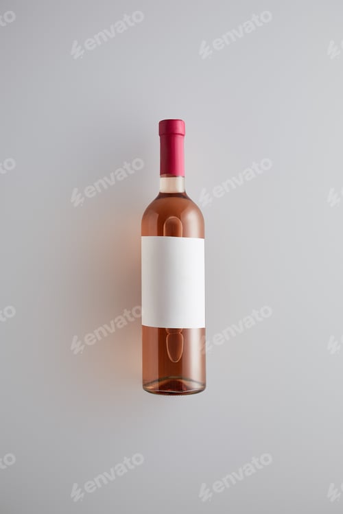 Preview: top view of bottle with rose wine and blank label on white background