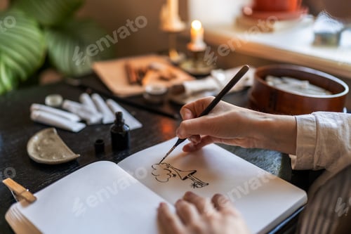 Preview: Artist holding fountain pen drawing with ink, creating artwork