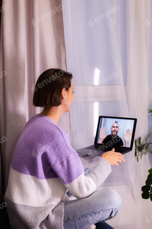 Preview: Woman at home face time video call her friends husband boyfriend, chatting online from laptop