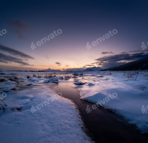Preview: Lofoten islands, Norway. Mountains, ice with snow and clouds during sunset. Evening time.