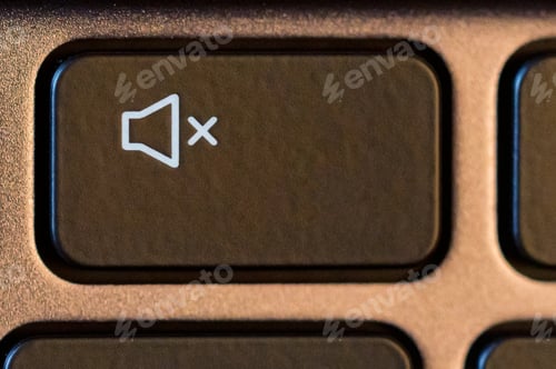 Preview: Close up of black turn off sound button on gray keyboard