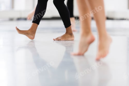 Preview: Legs and bare feet of young women dancers dancing