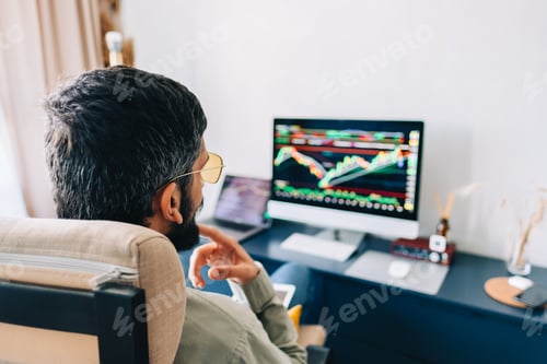 Preview: Caucasian businessman trading online, using computer technology, looking on stock exchange