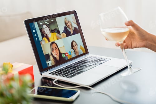 Preview: Young woman celebrating with wine in video call meeting with family during Christmas eve