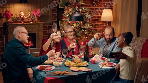 Preview: Beautiful african american woman with smartphone taking selfie photo of family celebrating winter