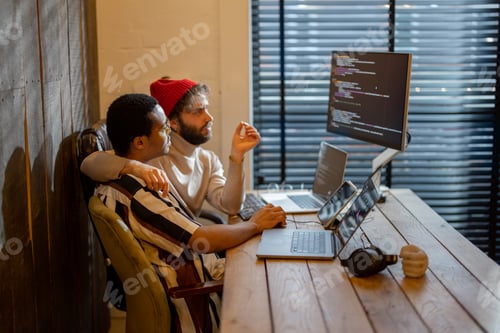 Preview: Gay couple working on computers at home office