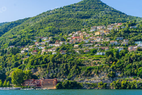 Preview: Multicolor houses building architecture on lake Como, Italy city. Green mountain hill village
