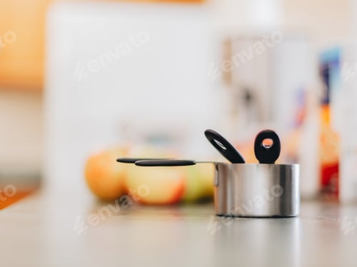 Preview: Messing cups on counter alongside apples, start of the making of apple crisp