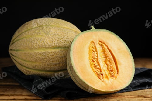 Preview: Tasty fresh melons on wooden table, closeup