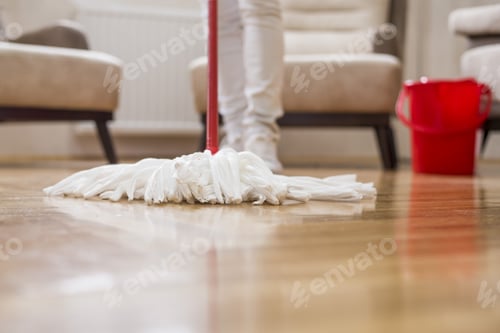 Preview: Selective focus shot of a female cleaning the floor with a mop