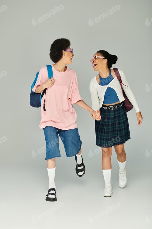 Preview: Two friends joyfully walking together, sporting colorful outfits in a creative studio setting