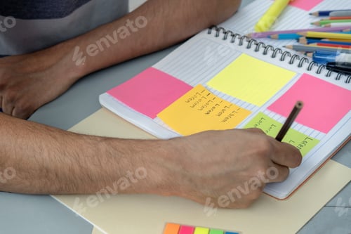 Preview: A student writing and making notes in a notebook