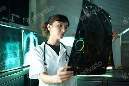 Preview: Portrait of young doctor checking X-Ray in hospital to make diagnosis