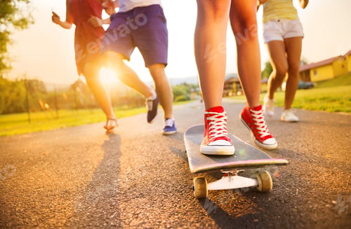 Preview: Young peoples legs with skateboard