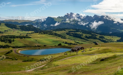 Preview: Cottages and a lake at Seiser Alm in the Dolomites mountains