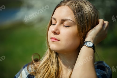 Preview: beautiful girl in a dress walking in the spring forest where the trees bloom