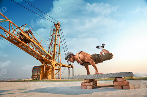Preview: Athletic man doing exercise push ups on hands