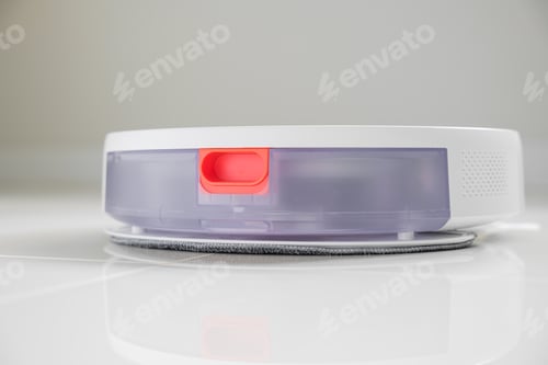 Preview: White automatic floor cleaner with side brush on tile flooring. Back view shows clear dustbin and