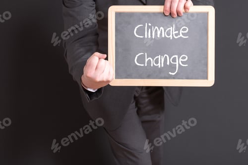 Preview: Businessman holding a board with "Climate change" text
