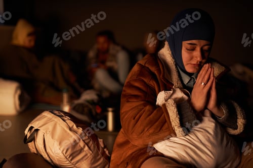 Preview: Middle Eastern woman praying in bomb shelter