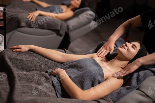 Preview: professional masseurs doctors doing anti-aging massage to clients