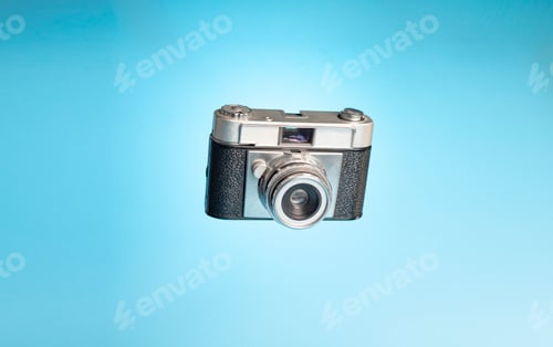 Preview: Vintage camera on a light blue background. Photography day concept