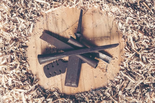 Preview: Carpenter tools on wooden table with sawdust. Carpenter workplace top view