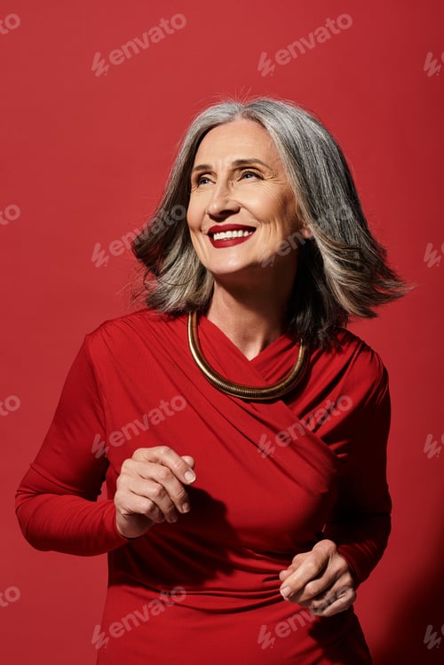 Preview: A joyful mature woman with grey hair celebrating the festive spirit of Christmas and New Year