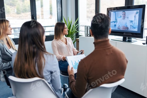 Preview: Smart business people working while doing a video call with company director in coworking place.