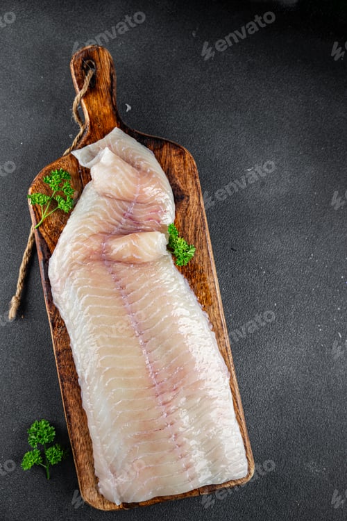 Preview: fish fillet raw white giant sea bass filleting fresh cooking meal food snack on the table copy space