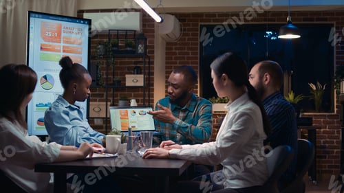 Preview: Coworkers brainstorming, analyst showing revenue statistics on laptop screen